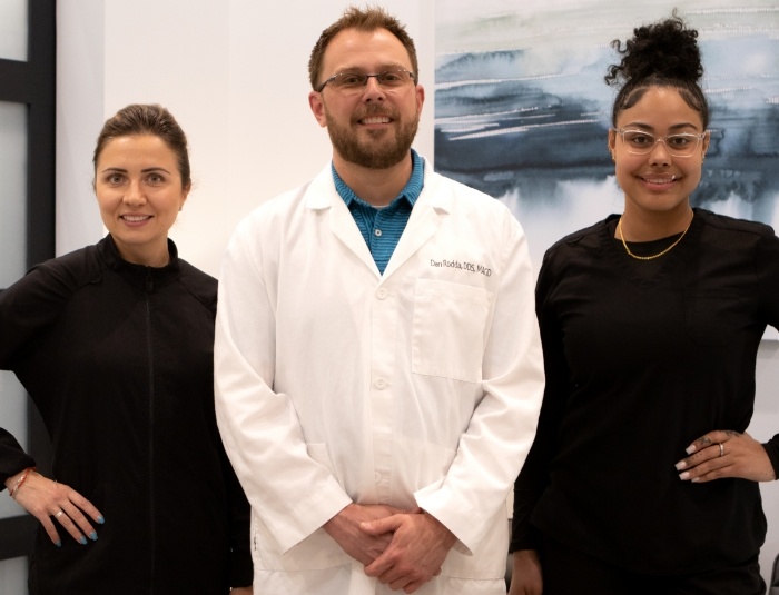 Phoenix Arizona dentist smiling with two dental team members