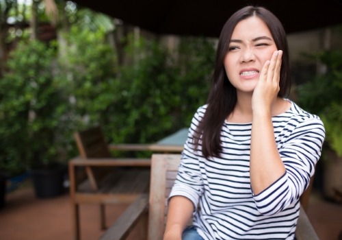 Woman holding the side of her face in pain