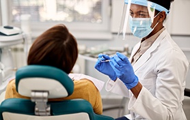Dentist smiling at patient during dental exam