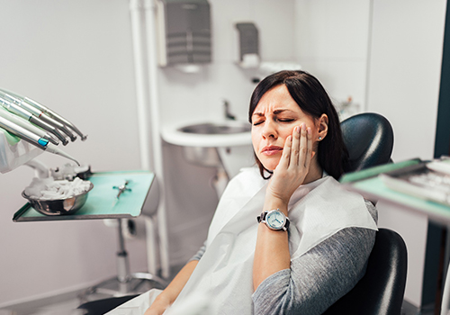 Woman with toothache at dentist's office in Phoenix 