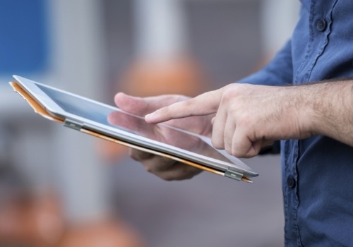 Person typing on tablet