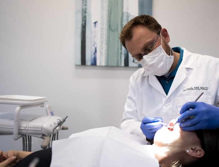 Doctor Rodda giving a dental patient gum disease treatment in Phoenix