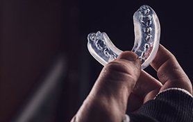 a person holding a mouthguard