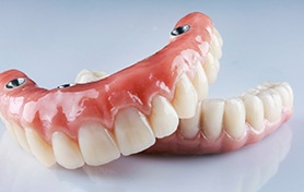 Removable implant dentures against neutral background