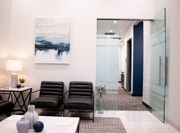 Waiting room with glass doors to hallway in Phoenix dental office