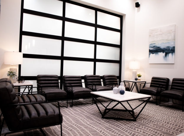 Empty black chairs in dental office waiting room