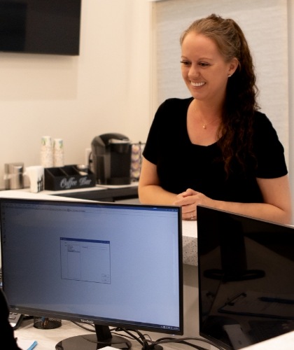 member of dental staff smiling with patient
