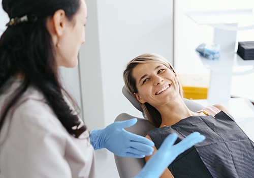 a dentist talking with their patient