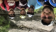 Selfie of Doctor Rodda with three other men wearing bike helmets