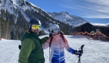 Doctor Rodda skiing on a snowy mountaintop with his partner