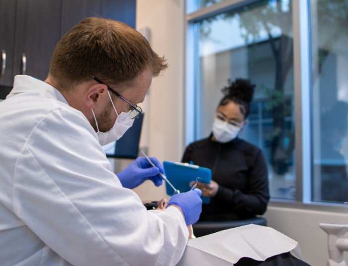 Doctor Rodda performing dental exam during preventive dentistry visit