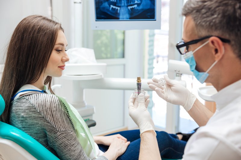 A dentist explaining the dental crown process to his patient