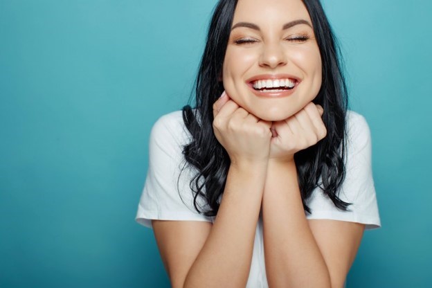 person with nice teeth thanks to dental implants smiling